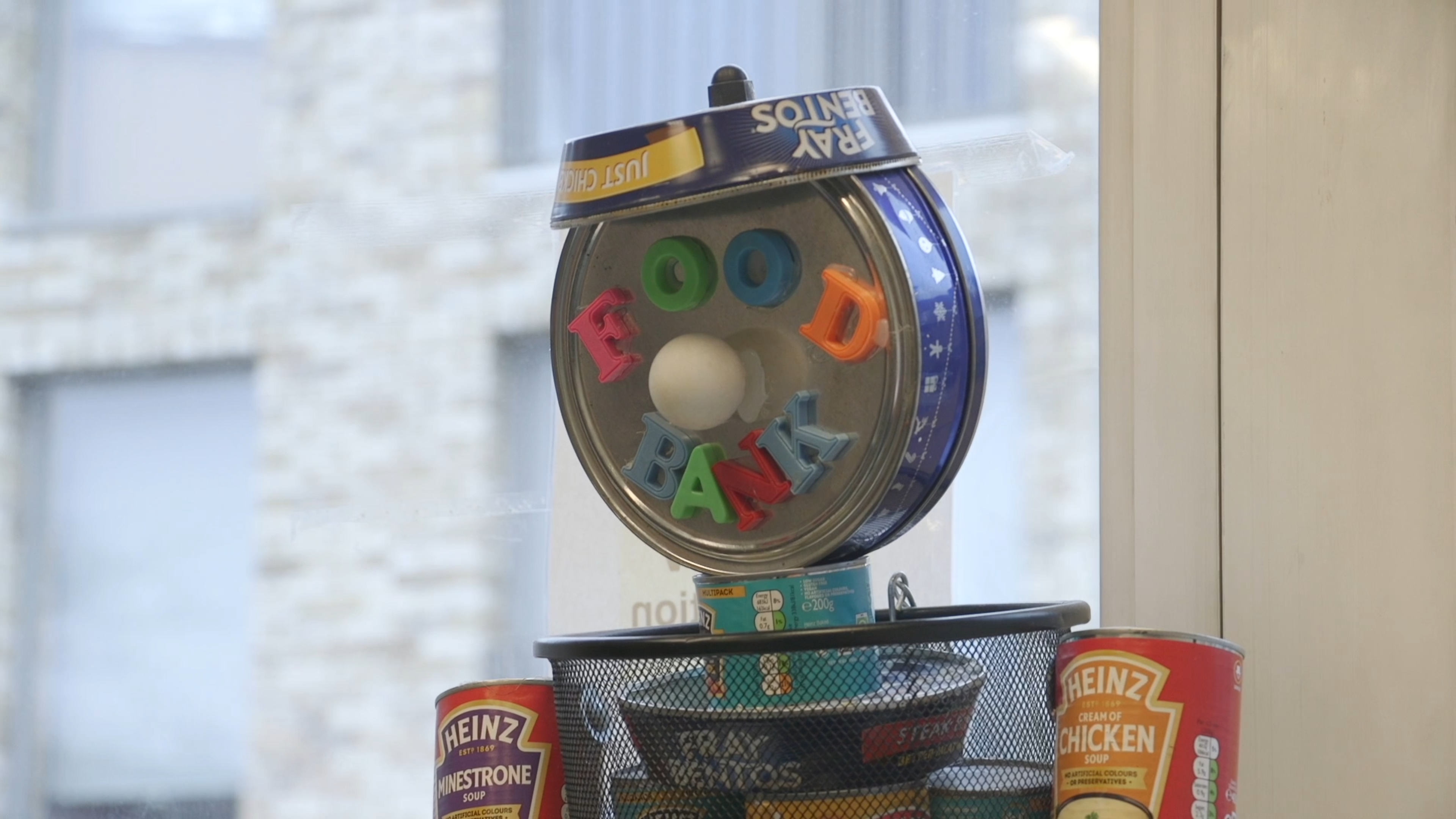 Food tins and colourful letters spelling FOOD BANK at Bow Food Bank
